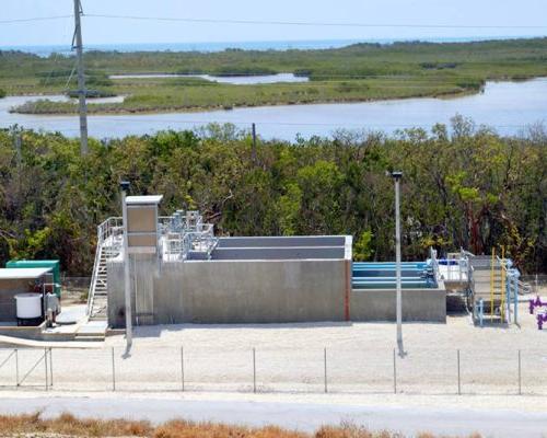 Looking down at the Layton wastewater treatment system. Purple and blue pipes extend out of the ground and system.